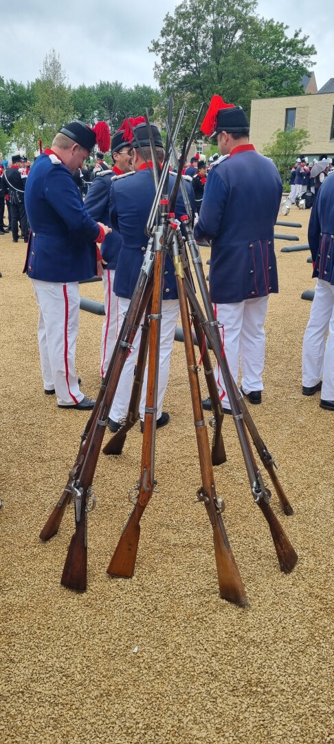 antique guns stacked together