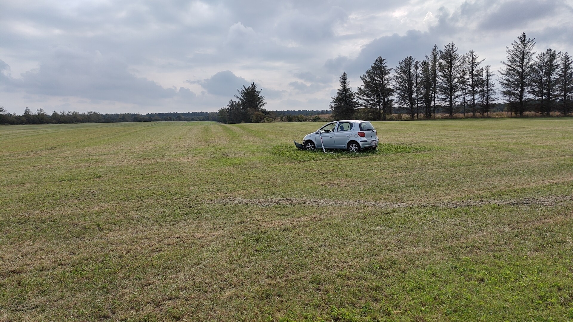 abandoned car in a field