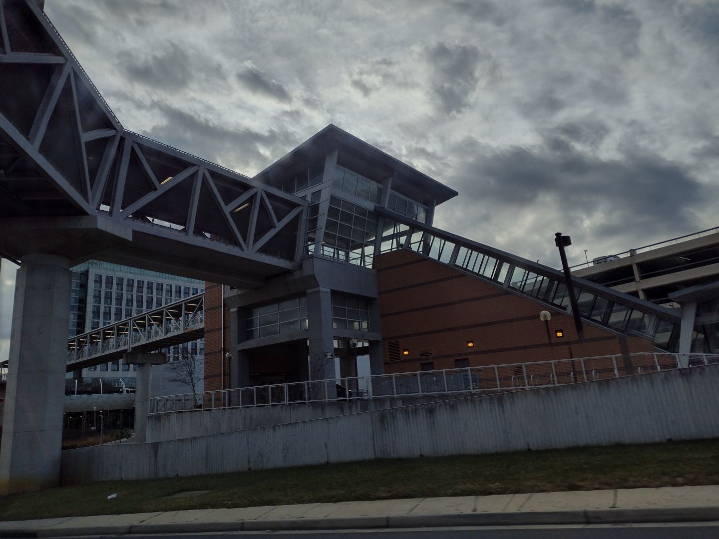 A geometric indoor walking bridge leading to a train station near Washington D.C. (taken from the road underneath)