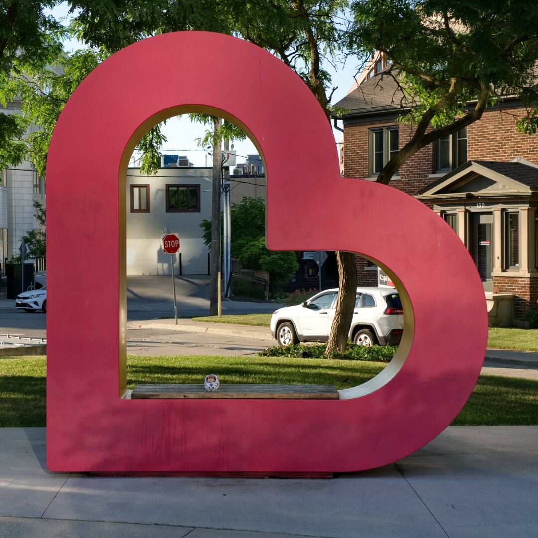 A Private Ham stuffed toy inside a Heart of Uptown sculpture.