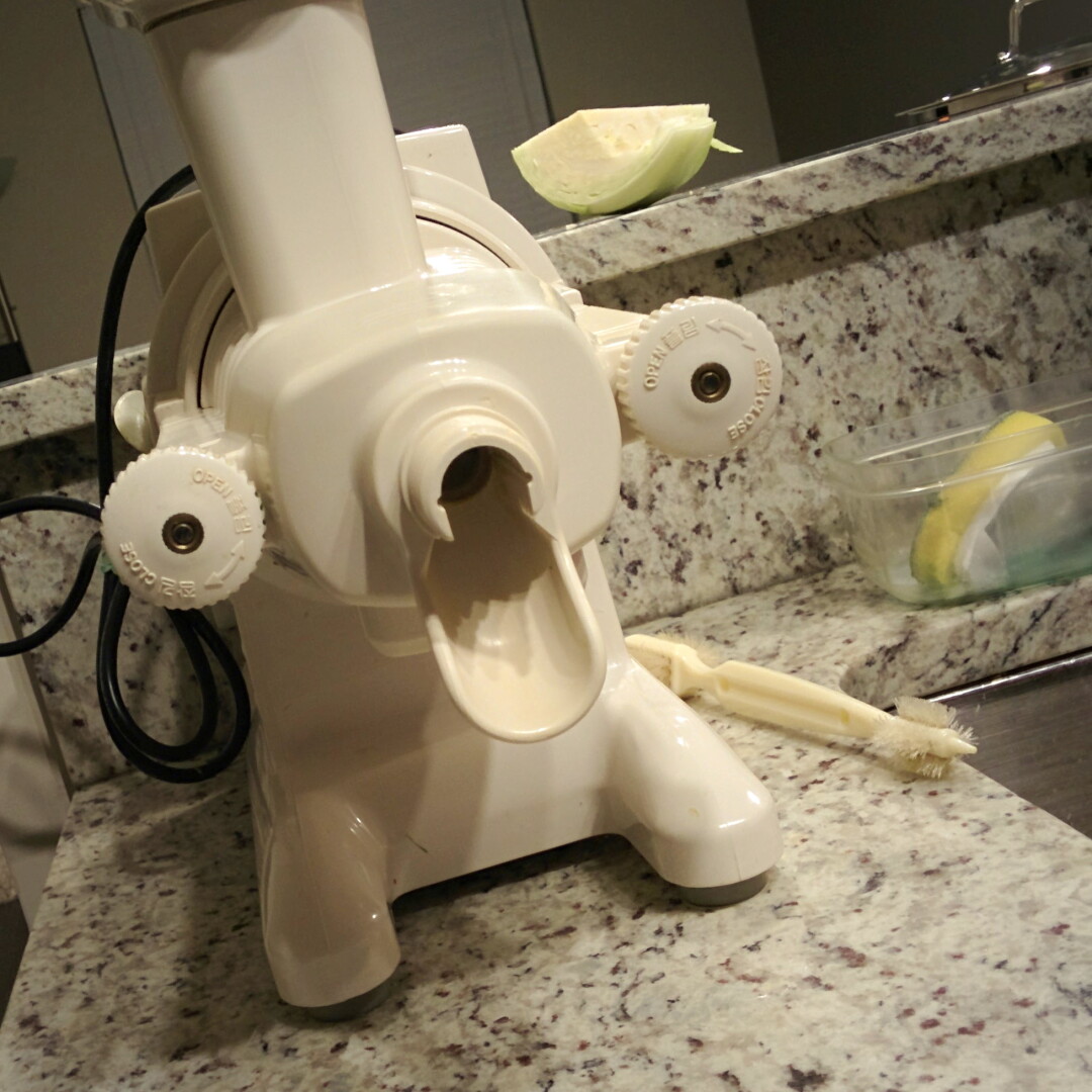 A photo of a juicer taken at a slight angle. The juicer has two knobs on each side of its spout that makes it look like it has seen some things.