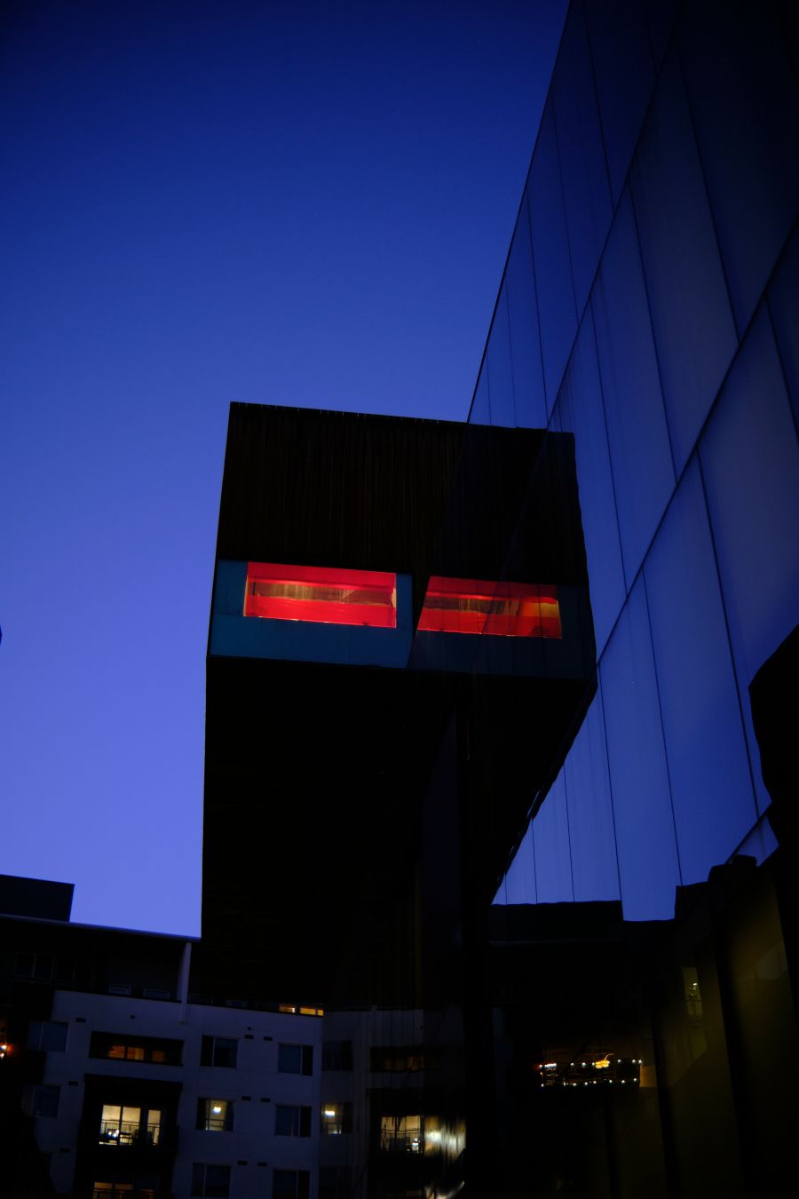 A deceptive photograph that appears to show a room with two red windows hovering in midair.