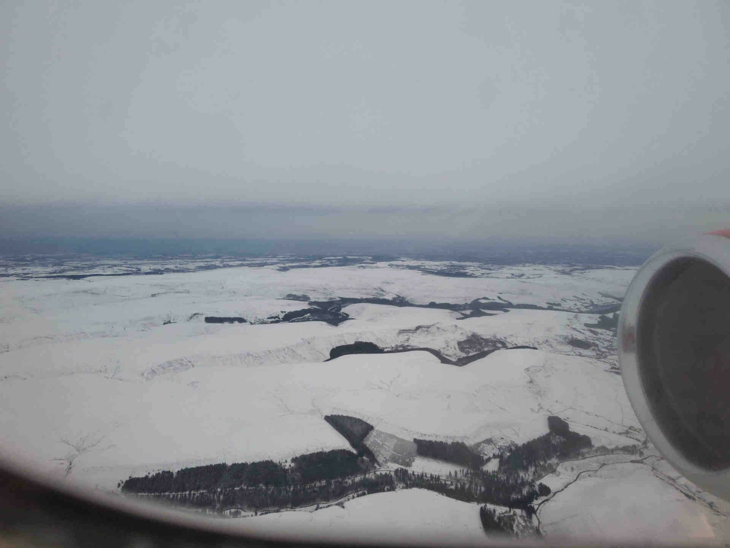 Snow-covered moorland, with three large valleys cutting through it from left to right. From bottom to top, the valleys are Woodlands Valley, Alport Dale, and the Upper Derwent Valley.