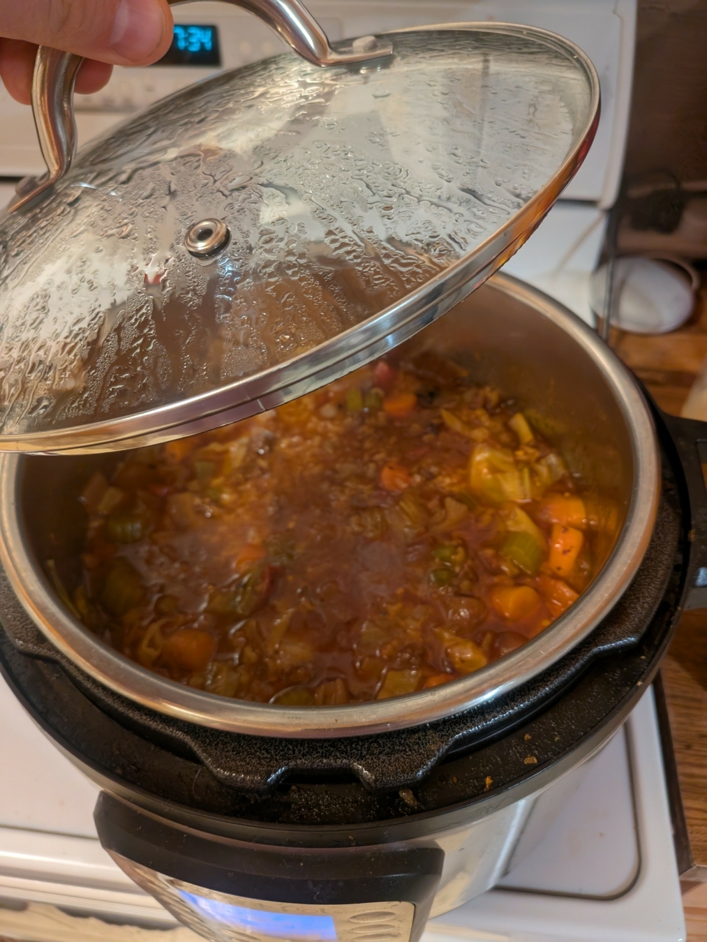 A tomato-based soup of cabbage, carrot, celery, rice and hamburger in an instant pot.