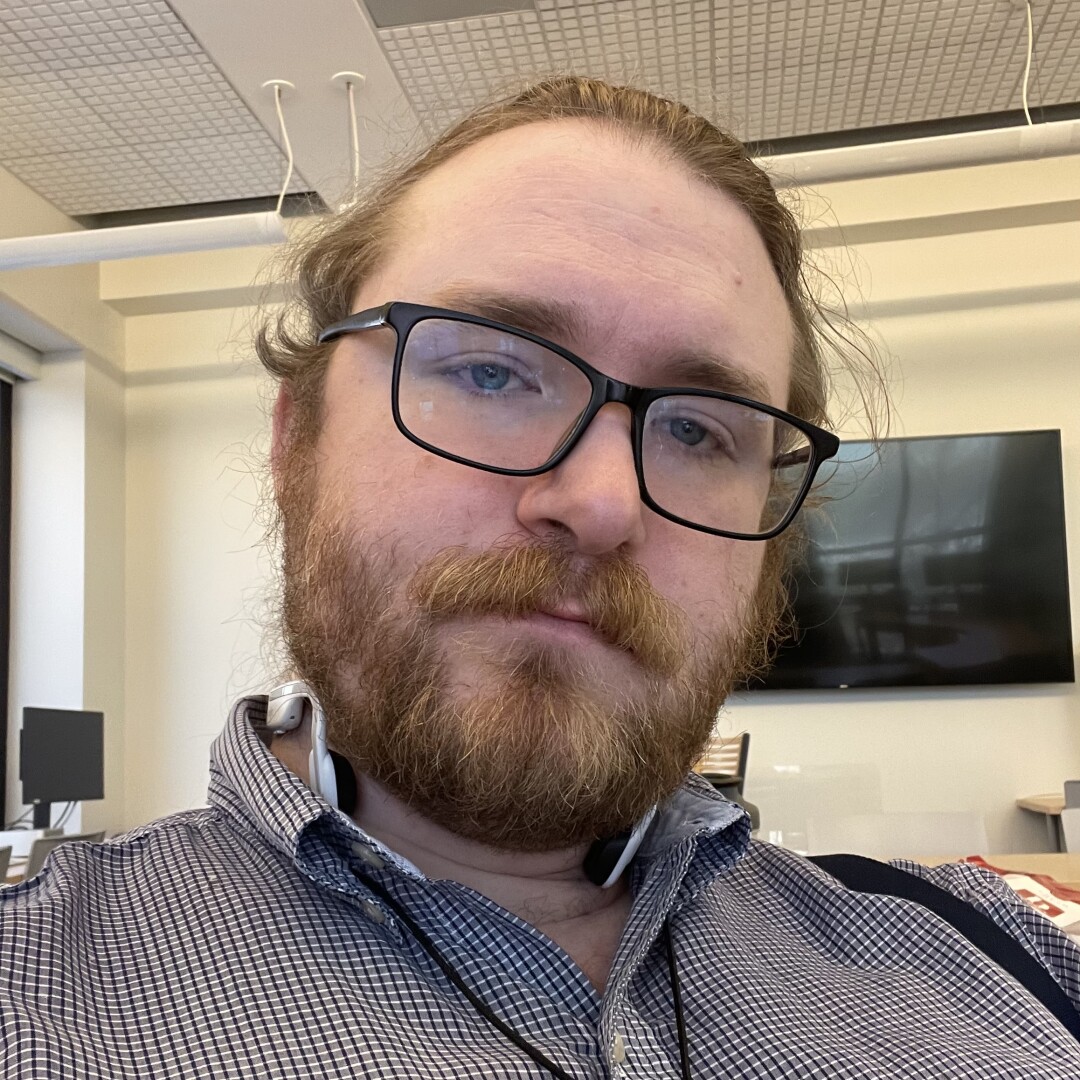 Bearded man in glasses looking into the camera.