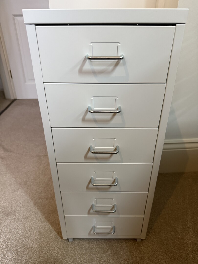 A six draw metal IKEA cabinet. All drawers closed.