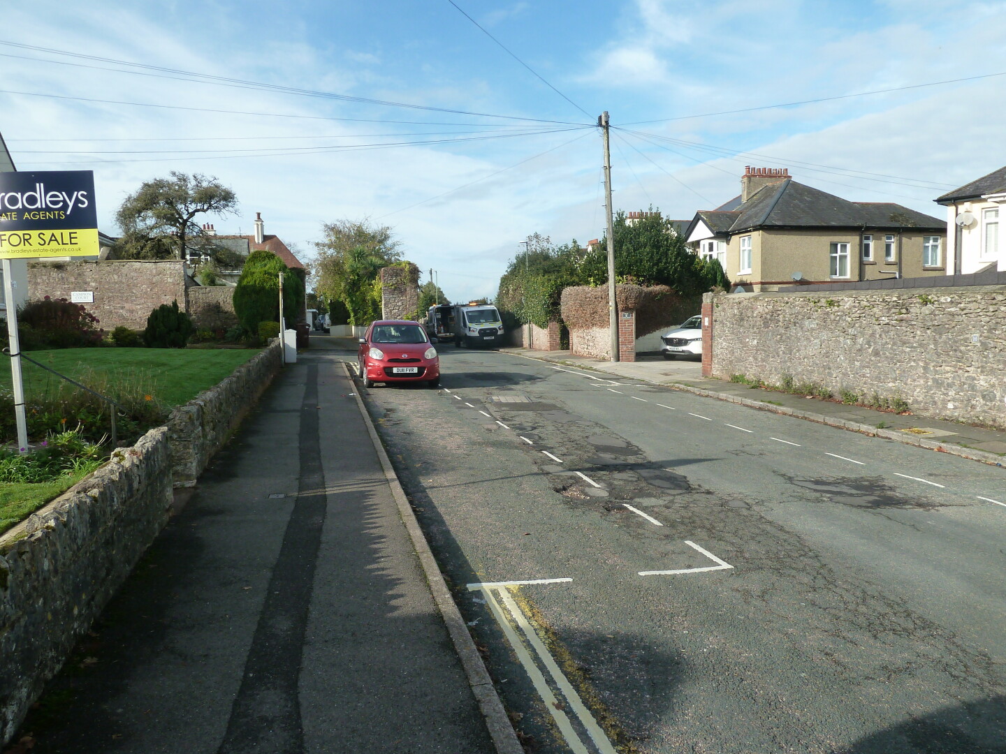 One of the roads in the area, with houses and other buildings.