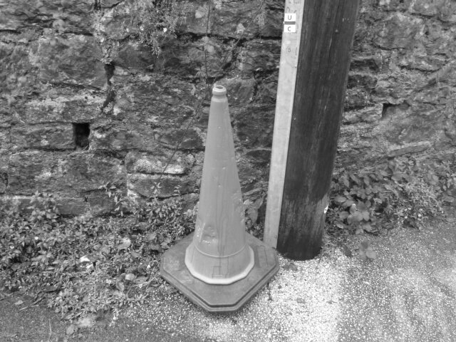 Cone at the side of the road.