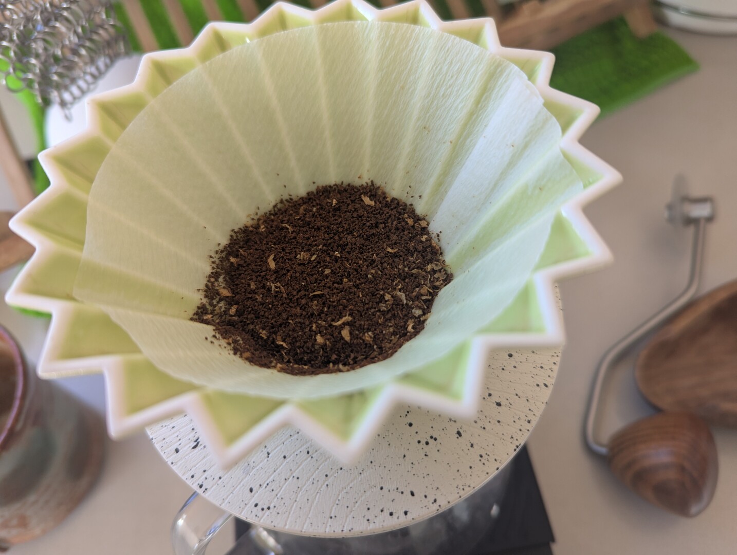 grounded coffee in origami dripper