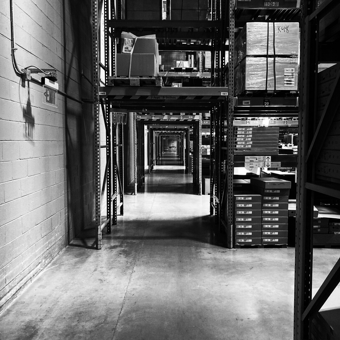 black and white high contrast photograph of a long corridor at an IKEA warehouse