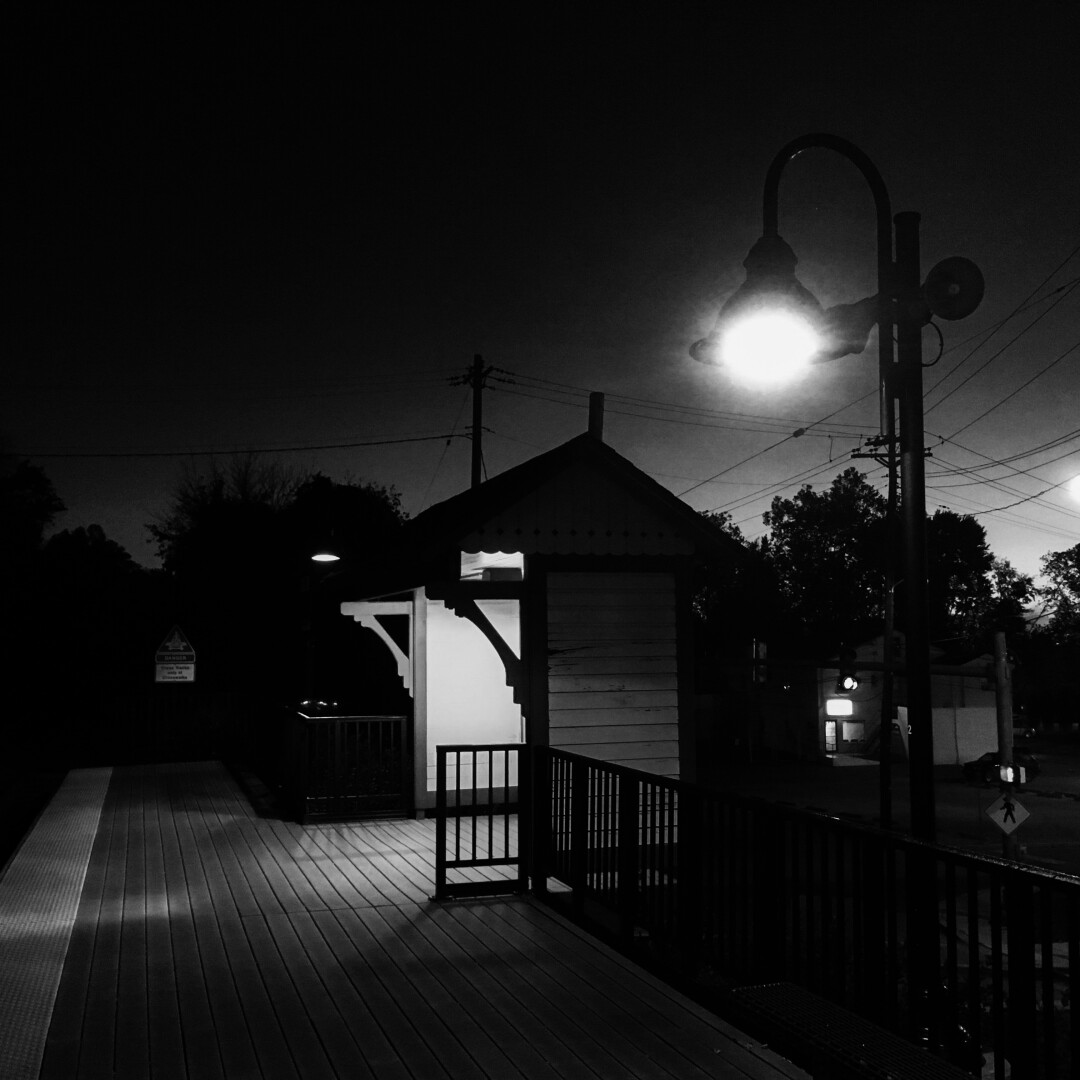 black and white photo of Laurel, Maryland, USA train station platform at night