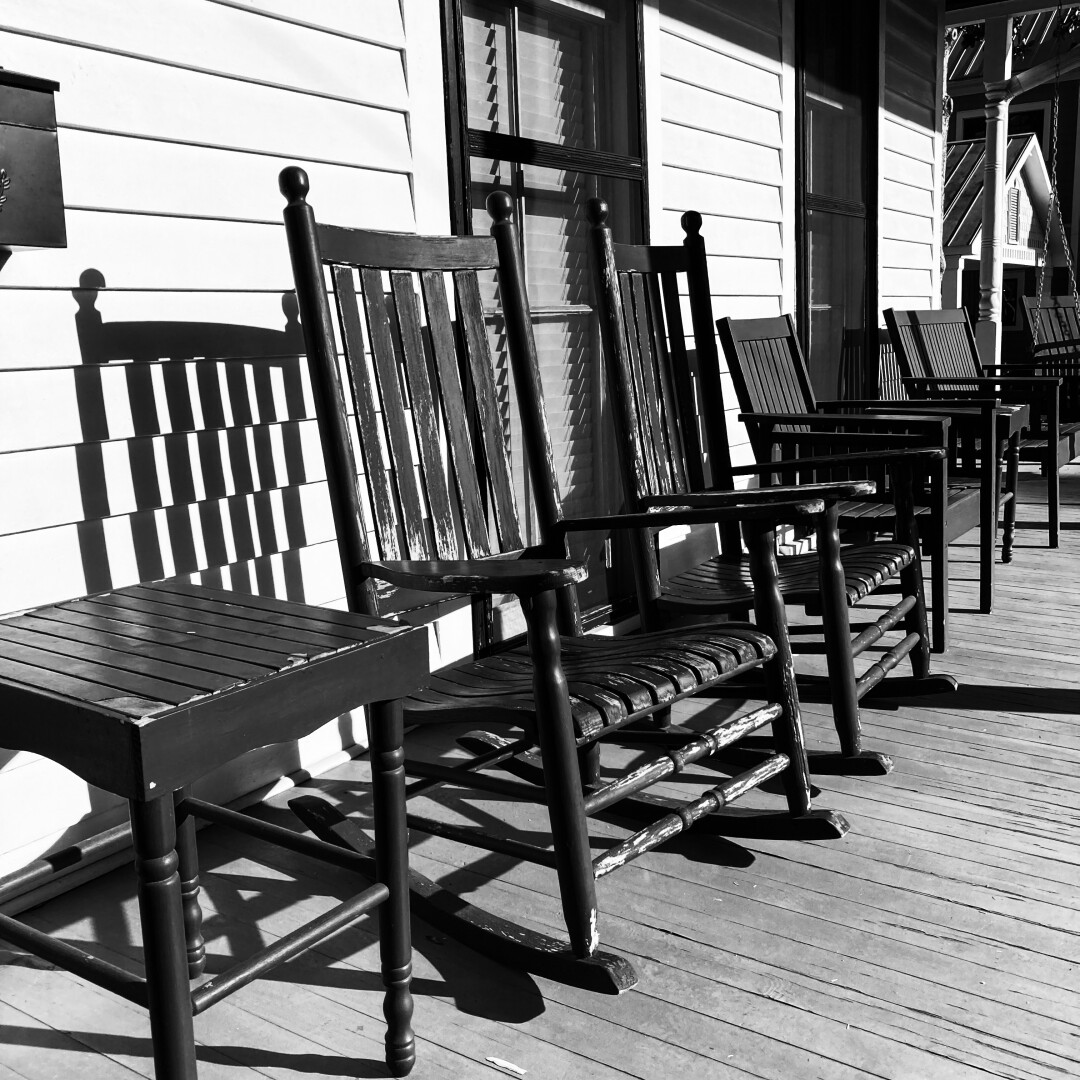 high-contrast black and white photo of chairs on a porch in Sylvania, Georgia, USA