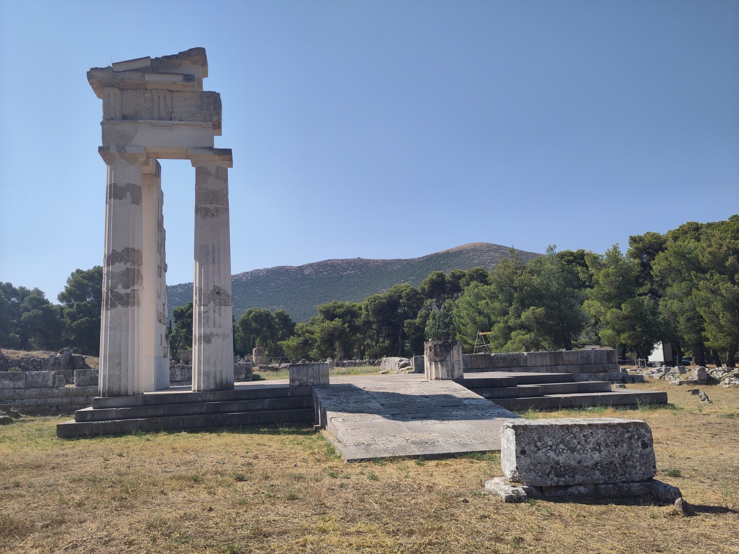 The Temple of Hygieia, the daughter of Asklepios who reigned over the concept of hygiene. The remains of the temple are mainly a small set of columns to the left, only the temple base and a couple column stumps remaining for the rest of the building.