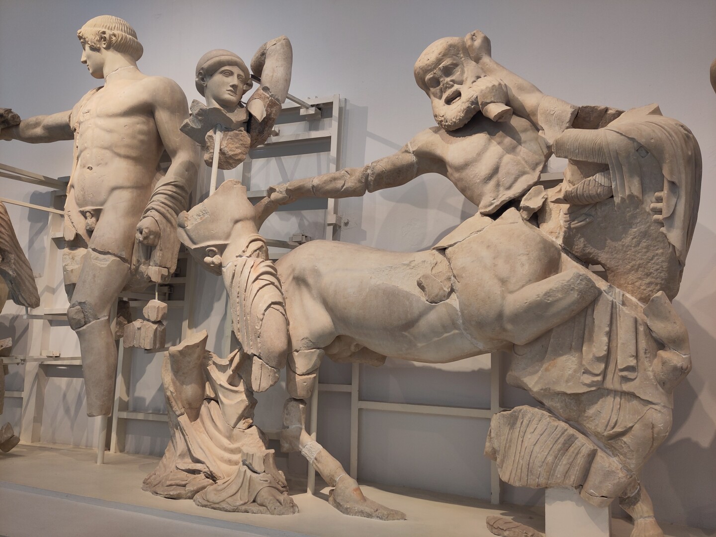 A few of the statues from the west pediment of the Temple of Zeus: to the left is Apollo (actually centered in the full pediment) with Theseus standing next  to him, hands raised to attack a Centaur held back by a Lapith woman. Battle between Centaurs and the Lapith people seems like it was a very popular thing to depict (already seen on the Parthenon at the Acropolis in Athens too).